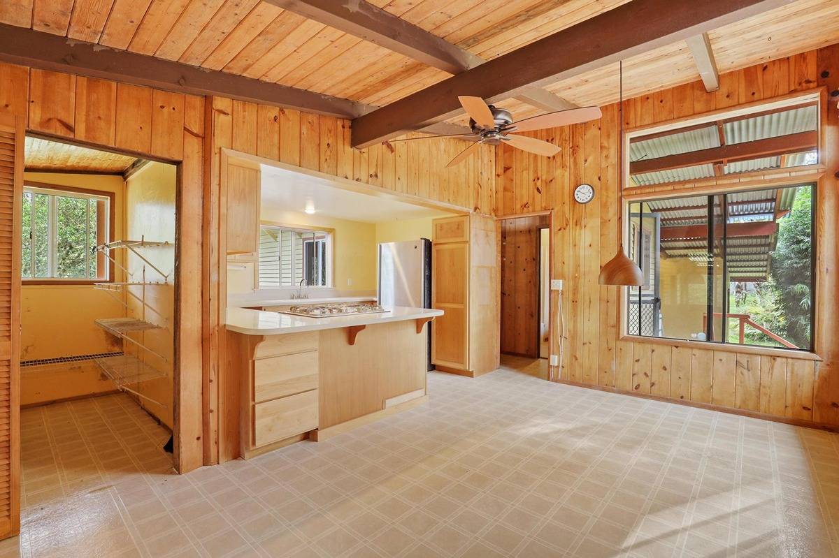 16-1585 Hopue Road, Unit 2 Mountain View, HI 96771 - Photo 8 of 29 a bathroom with a granite countertop sink and a mirror