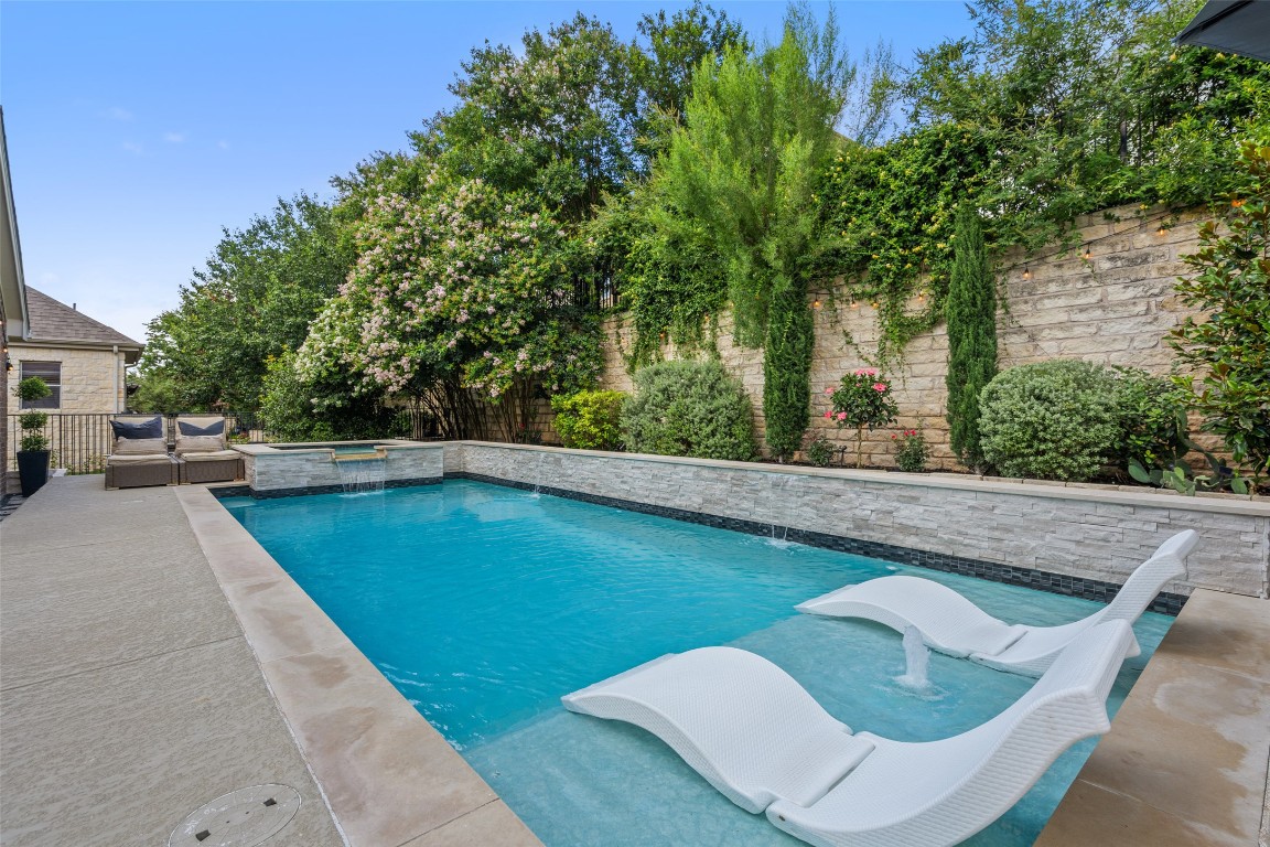 a view of swimming pool with seating space