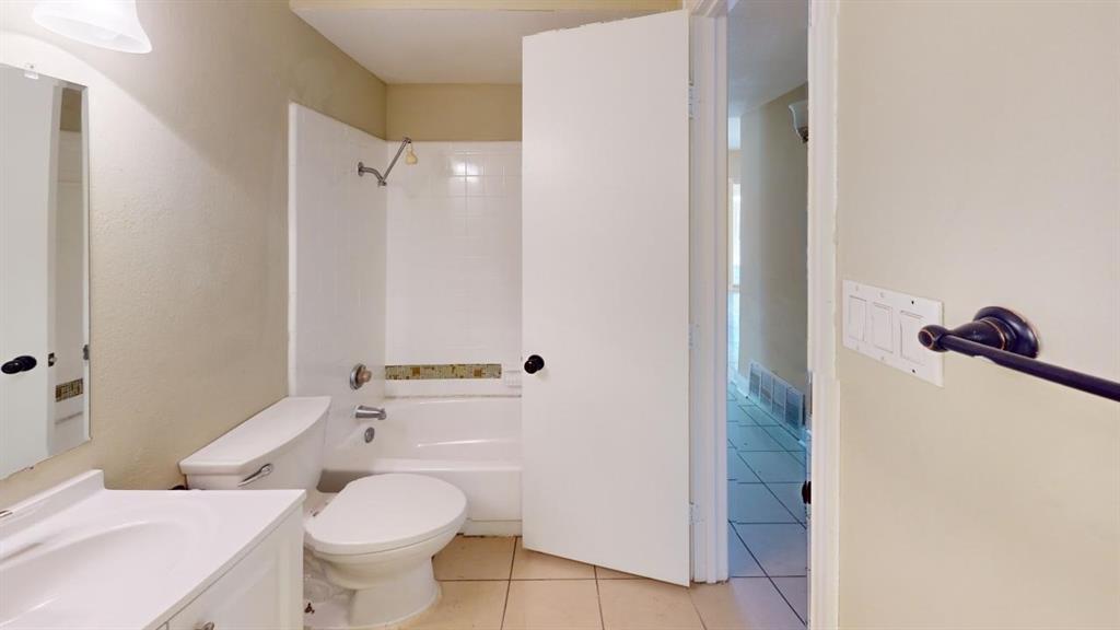 3005 Meandering Way Bedford, TX 76021 - Photo 17 of 22 a bathroom with a toilet a sink and shower