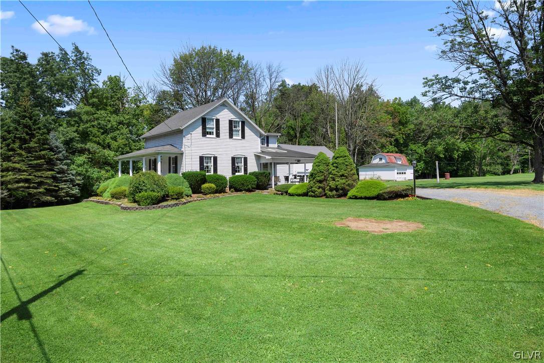 a house with green field in front of it