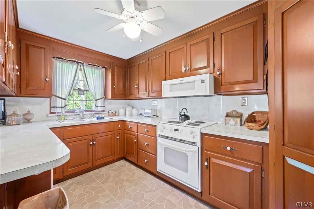 465 Belfast Road Nazareth, PA 18064 - Photo 6 of 32 a kitchen with stainless steel appliances granite countertop a stove a sink dishwasher and cabinets with wooden floor