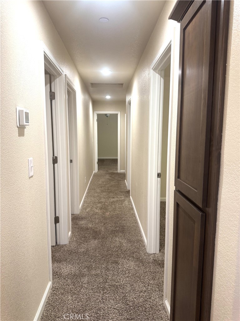 1339 Playa Del Rey Drive Merced, CA 95348 - Photo 18 of 48 a view of a hallway with wooden shelves