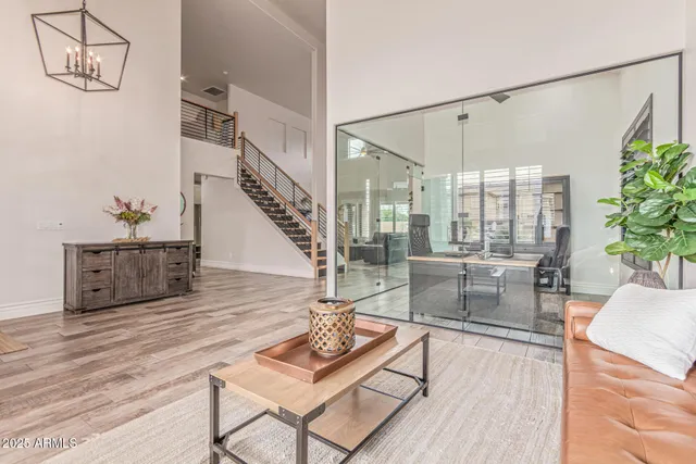 a dining room with furniture a chandelier and wooden floor