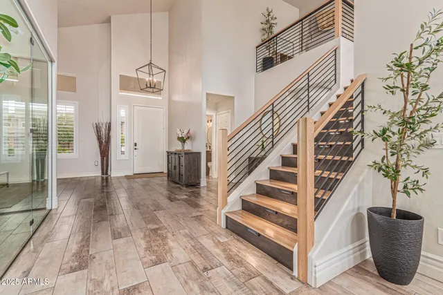 a kitchen with stainless steel appliances granite countertop a table chairs and a refrigerator