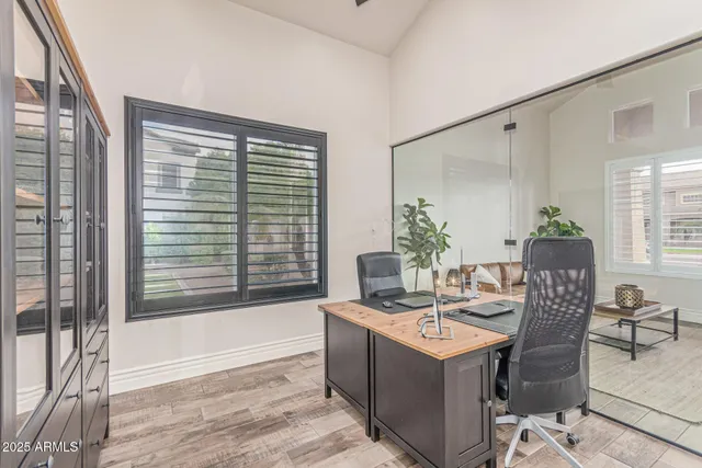 a kitchen with stainless steel appliances kitchen island granite countertop a dining table and chairs