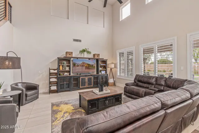 a living room with furniture and ceiling fan