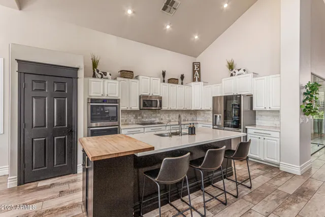 a bedroom with a bed and a chair with the view of wooden floor