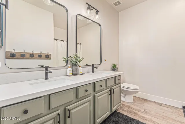 a view of house with a big yard and potted plants