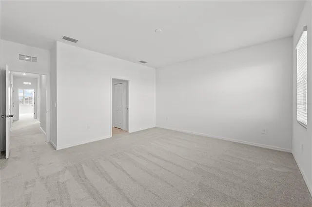 a dining room with furniture and a potted plant