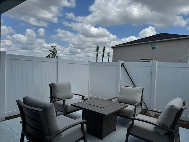 an aerial view of a house with a garden and lake view