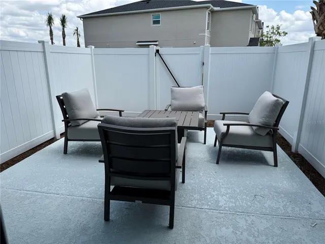a view of swimming pool with outdoor seating and city view