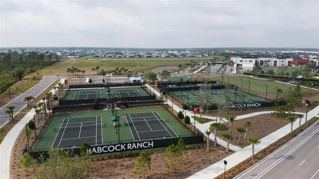 an aerial view of a house a yard swimming pool and outdoor seating