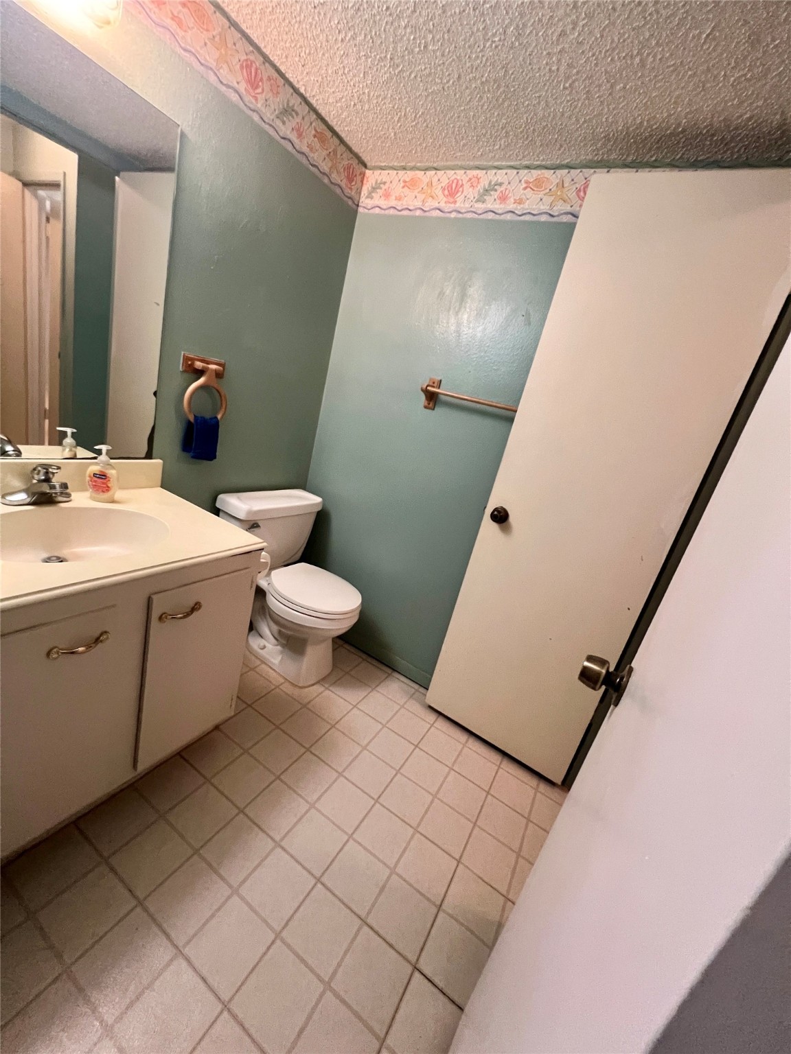 307 Jill Street Conroe, TX 77303 - Photo 13 of 20 a bathroom with a sink a toilet and mirror