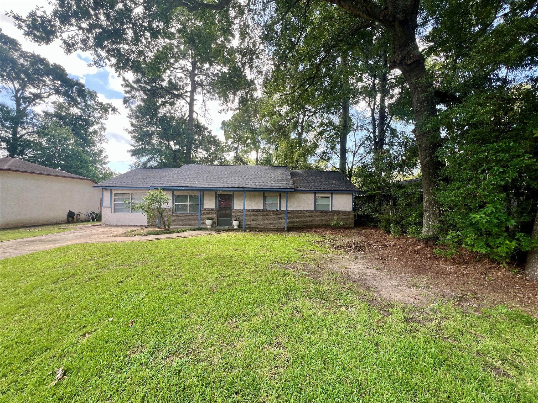 307 Jill Street Conroe, TX 77303 - Photo 20 of 20 a front view of a house with a yard
