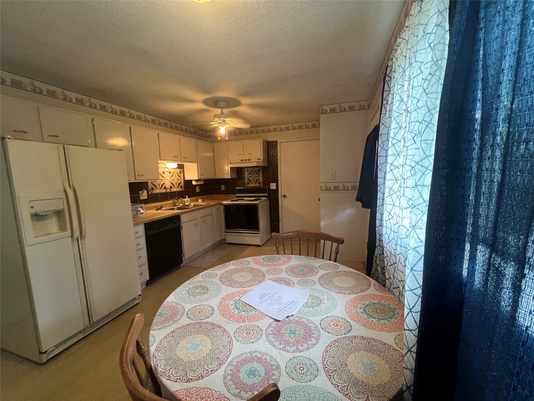 307 Jill Street Conroe, TX 77303 - Photo 4 of 20 a kitchen with stainless steel appliances granite countertop a sink stove and refrigerator