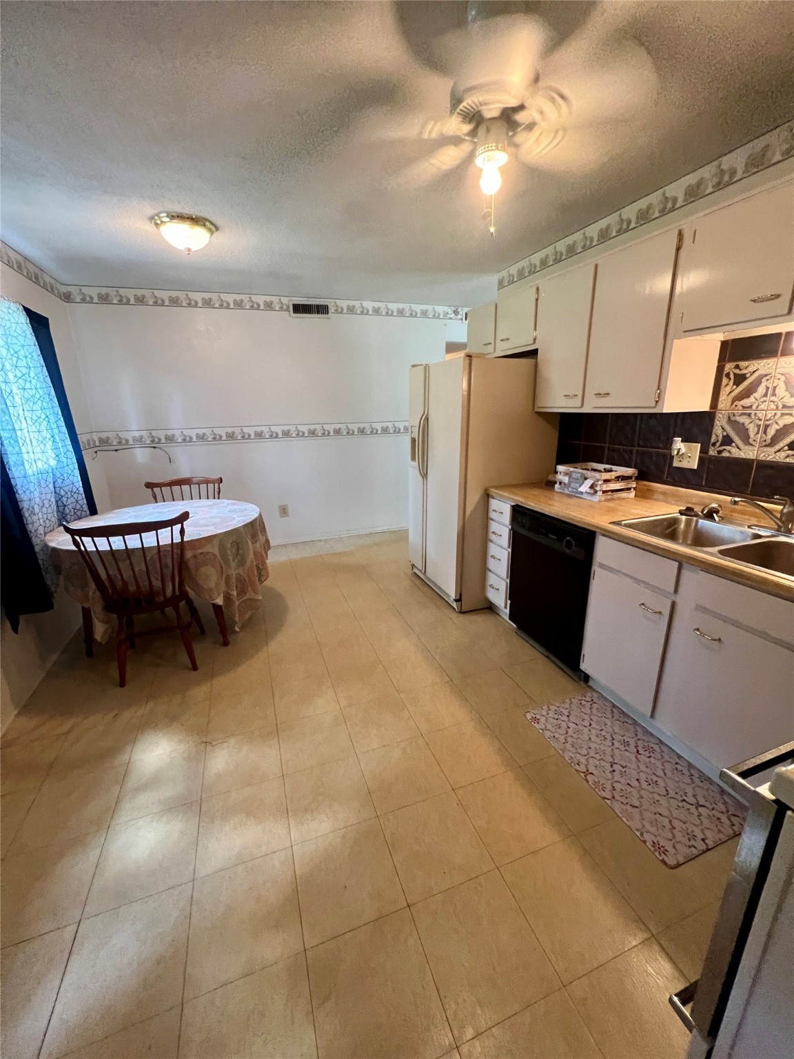 307 Jill Street Conroe, TX 77303 - Photo 8 of 20 a kitchen with a cabinets and a refrigerator