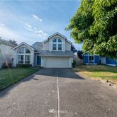 a front view of a house with a yard and garage