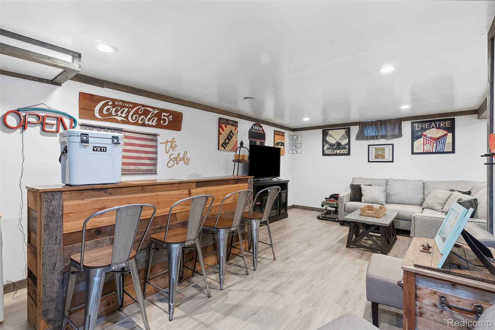8403 Miller Road Swartz Creek, MI 48473 - Photo 24 of 37 Reclaimed wood-finish bar area with seating for four, wood-finish flooring, recessed lighting, and white walls