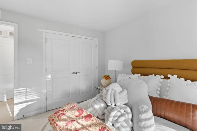 a bedroom with a bed and a mirror