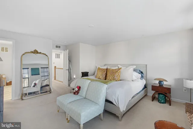 a bedroom with a bed and a mirror