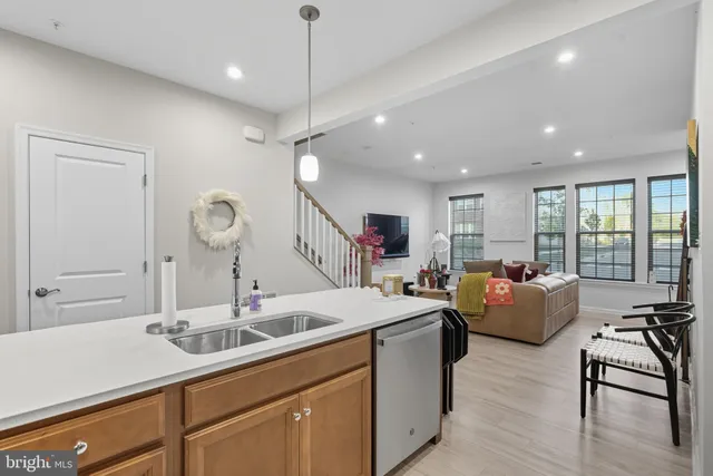 a kitchen with living room and white cabinets
