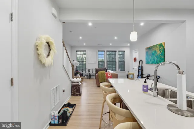 a living room with furniture gym equipment and a chandelier