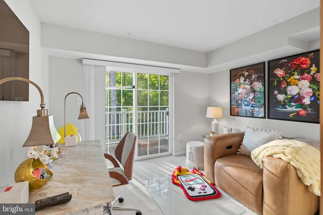 a bedroom with furniture and a large window