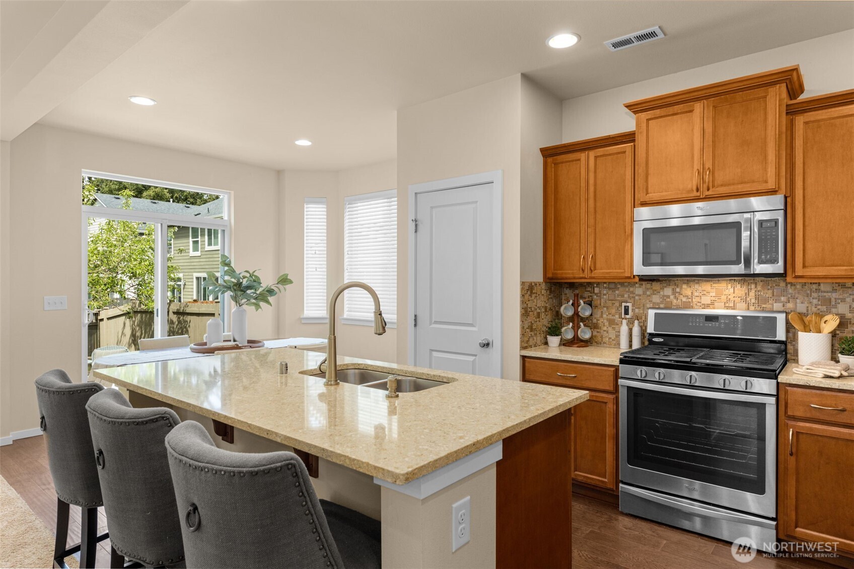 18525 115th Place Southeast Renton, WA 98055 - Photo 7 of 29 a kitchen with kitchen island granite countertop a stove top oven a sink a counter space and dining table