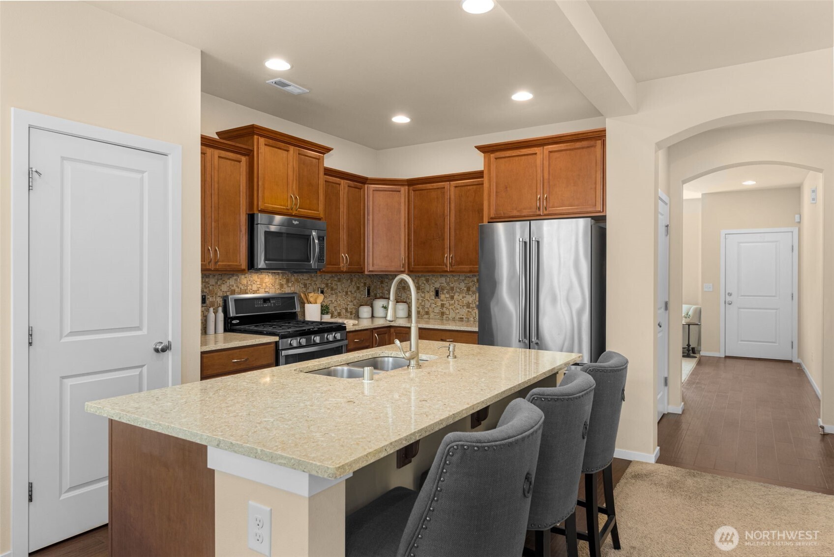 18525 115th Place Southeast Renton, WA 98055 - Photo 8 of 29 a kitchen with stainless steel appliances granite countertop a table chairs sink refrigerator and microwave