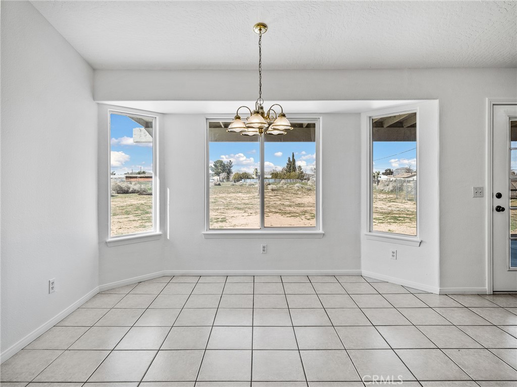 14266 Kiowa Road Apple Valley, CA 92307 - Photo 15 of 27 Enjoy your morning coffee while overlooking your private 1-acre backyard in this sun-drenched dining area filled with natural light.