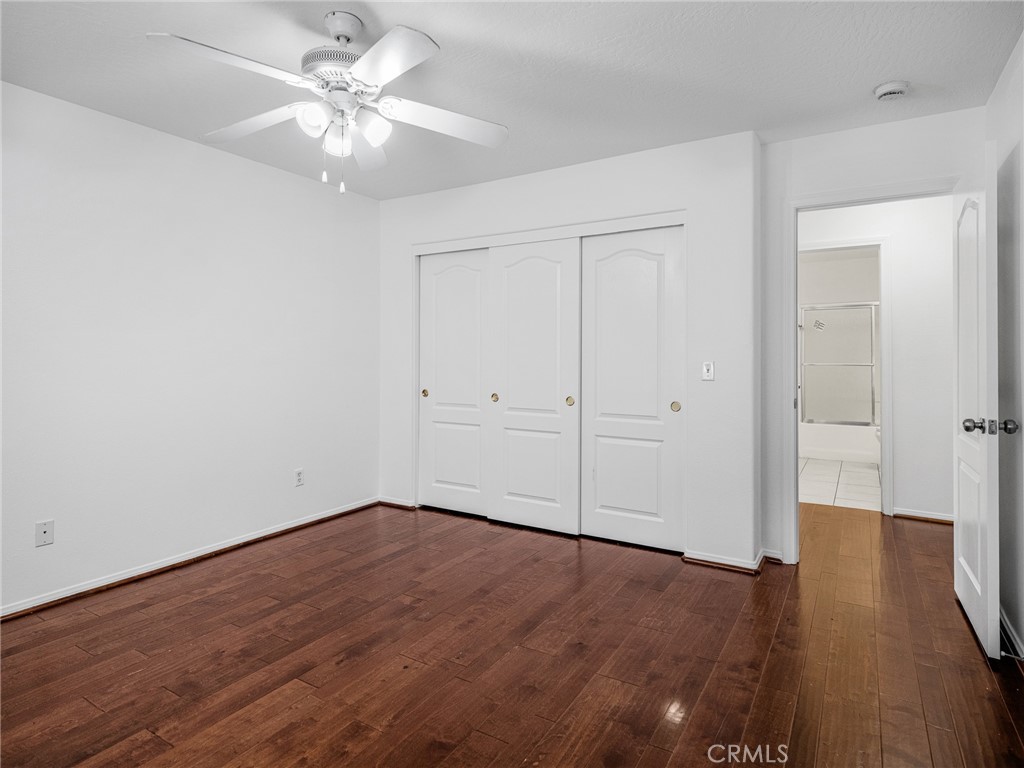 14266 Kiowa Road Apple Valley, CA 92307 - Photo 19 of 27 Bright bedroom with updated flooring, fresh paint, ceiling fan and generous closet space.