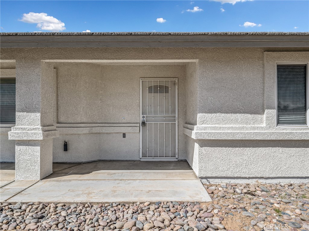 14266 Kiowa Road Apple Valley, CA 92307 - Photo 3 of 27 Inviting covered front door alcove offering shade, protection from the elements, and a welcoming entrance.