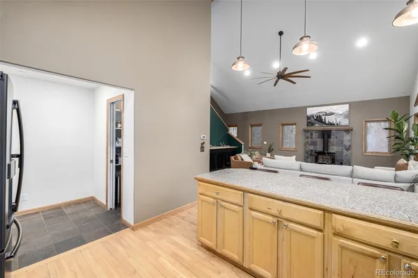 a view of living room with granite countertop furniture and a flat screen tv