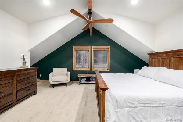 a bedroom with a bed dresser and a window