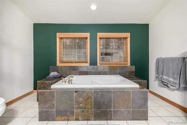 a bath tub sitting in a bathroom next to a window
