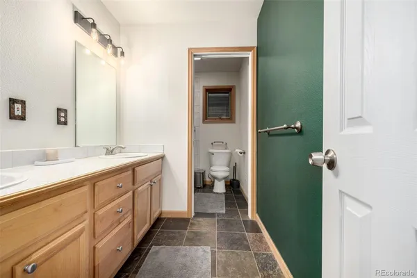 a spacious bathroom with a double vanity sink and a mirror