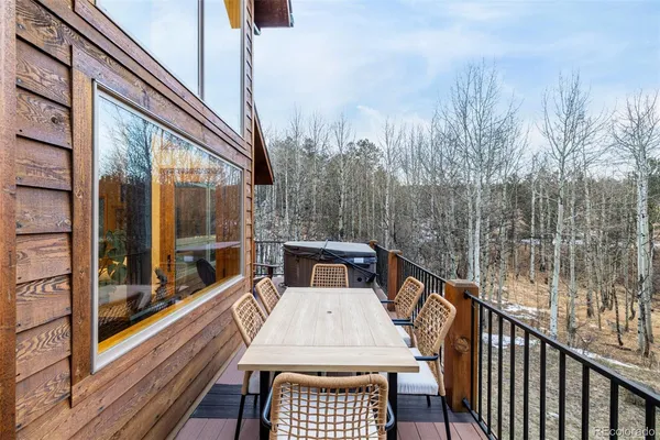 a view of a balcony with couches and wooden floor