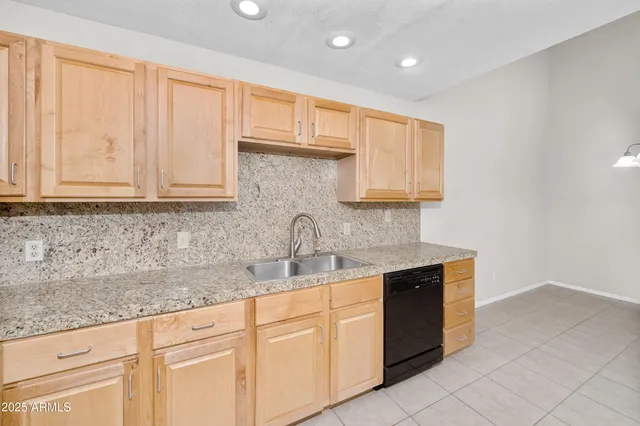a view of a kitchen with a refrigerator and a sink