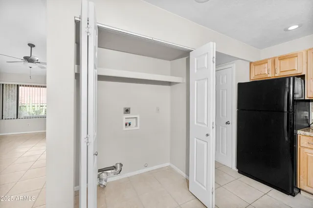 an empty room with fan and windows