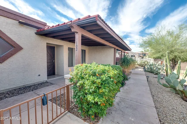 an empty room with a ceiling fan and carpet
