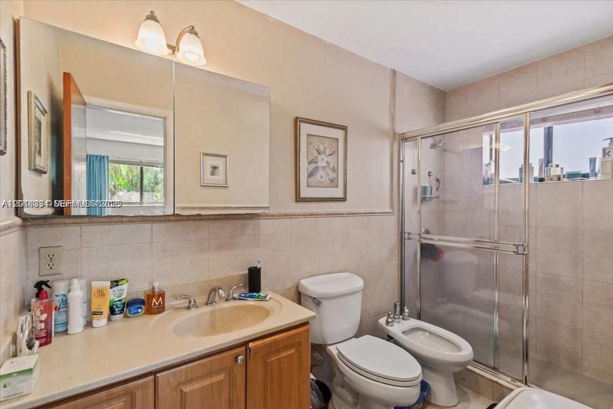 6385 Southwest 25th Street Miami, FL 33155 - Photo 16 of 28 a bathroom with a sink a toilet and a shower