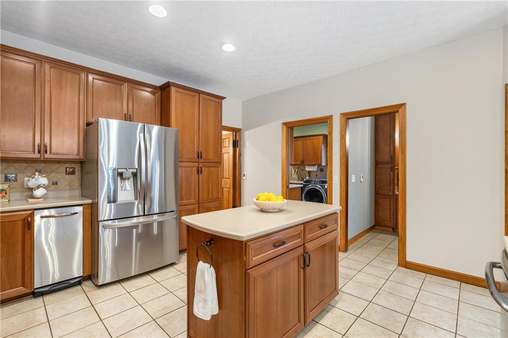 4275 Burtner Road Natrona Heights, PA 15065 - Photo 11 of 42 a kitchen with stainless steel appliances granite countertop a refrigerator and a stove top oven