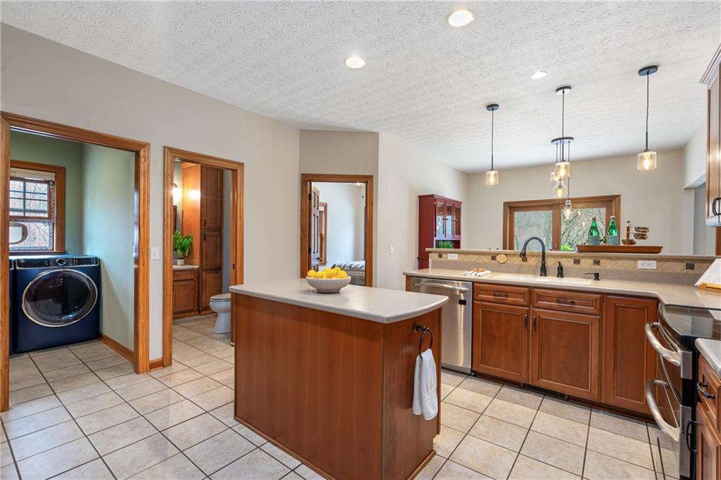 4275 Burtner Road Natrona Heights, PA 15065 - Photo 12 of 42 a kitchen with a sink a stove and cabinets