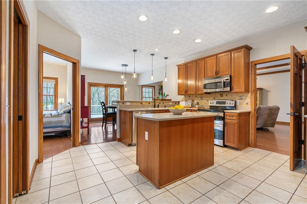 4275 Burtner Road Natrona Heights, PA 15065 - Photo 14 of 42 a kitchen with stainless steel appliances granite countertop a refrigerator and a stove top oven