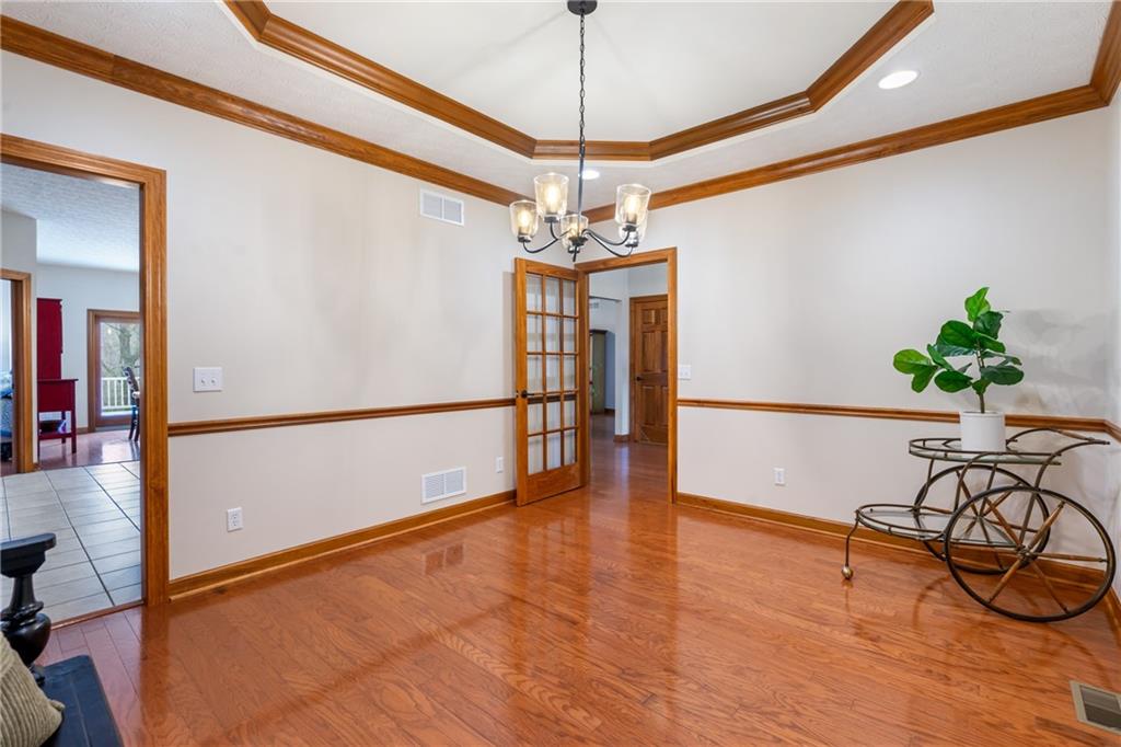 4275 Burtner Road Natrona Heights, PA 15065 - Photo 17 of 42 a view of a dining room with furniture wooden floor and a chandelier
