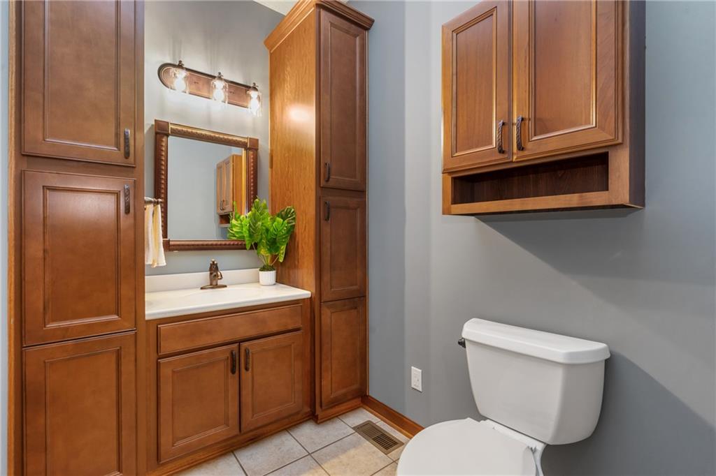 4275 Burtner Road Natrona Heights, PA 15065 - Photo 19 of 42 a bathroom with a toilet a sink and mirror