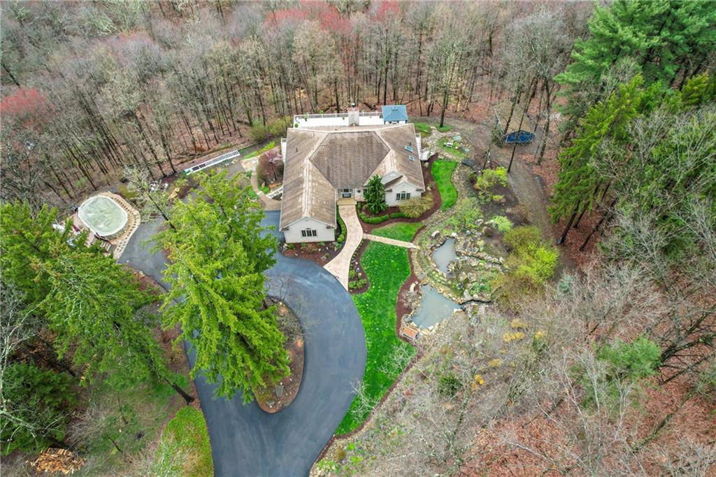 4275 Burtner Road Natrona Heights, PA 15065 - Photo 2 of 42 an aerial view of a house with a yard and swimming pool