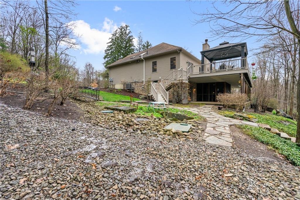 4275 Burtner Road Natrona Heights, PA 15065 - Photo 36 of 42 a view of a house with yard and a fire pit