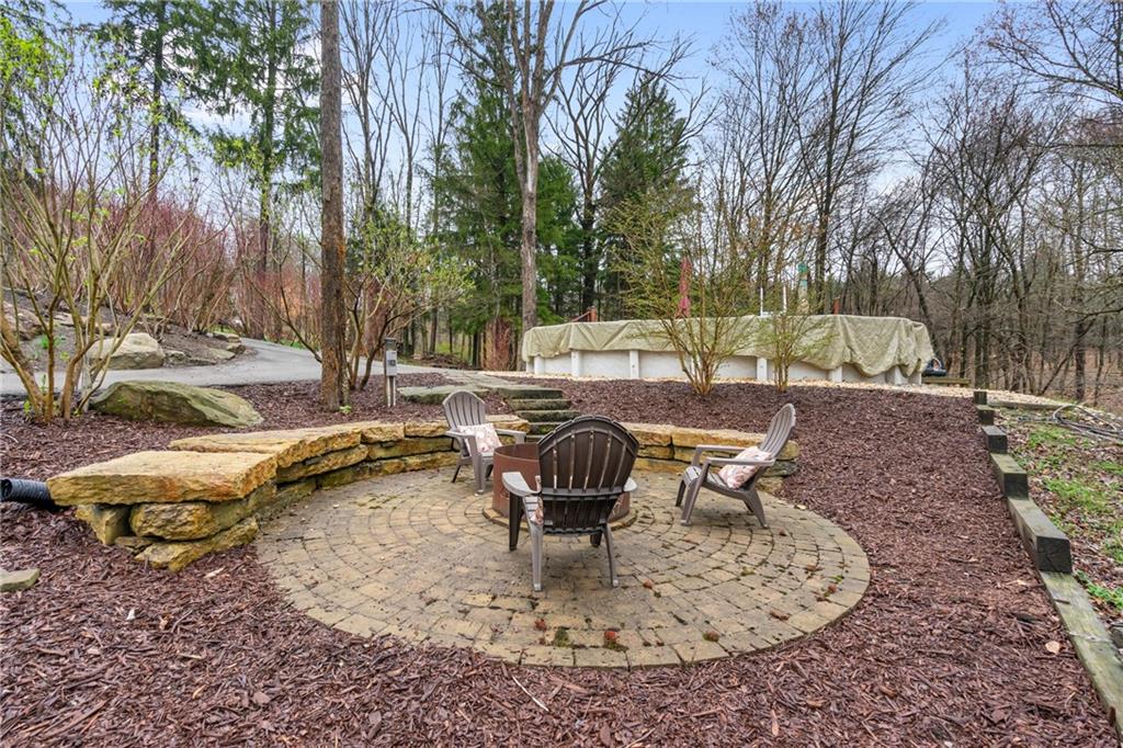 4275 Burtner Road Natrona Heights, PA 15065 - Photo 37 of 42 a view of a swimming pool with a sitting space