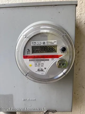 a room with water heater and a wooden door